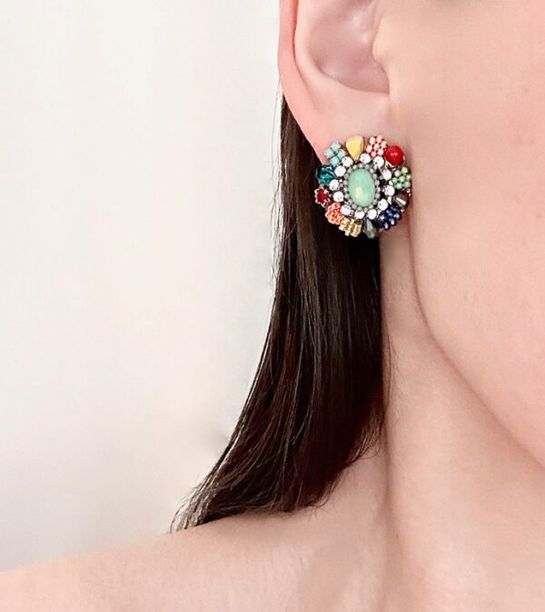 A woman's ear is decorated with E2111 stones.