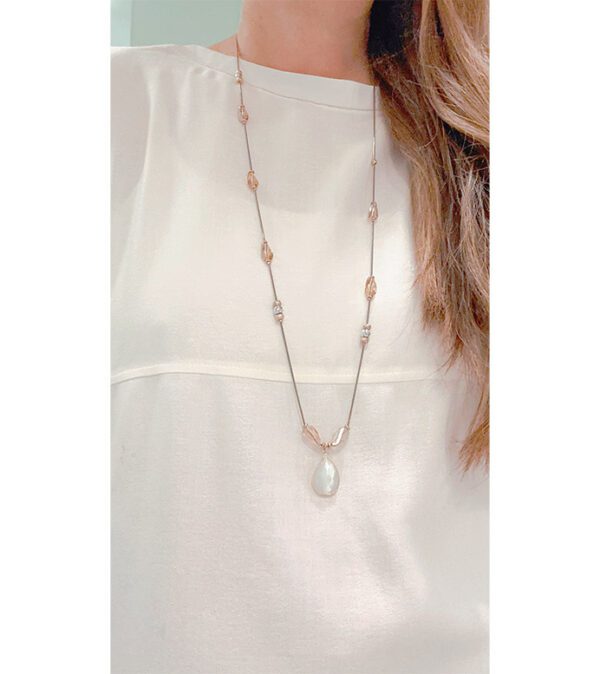 A woman wearing a white top and a NK8901 (Multi/ Light) necklace with pearls.