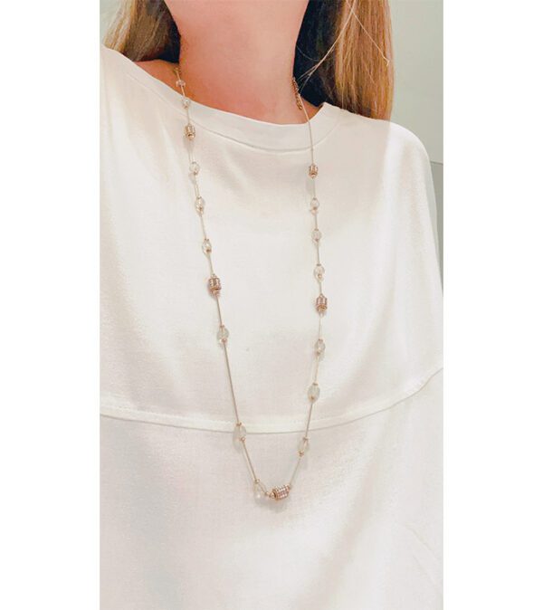 A woman wearing a white top and an NK8895 necklace.