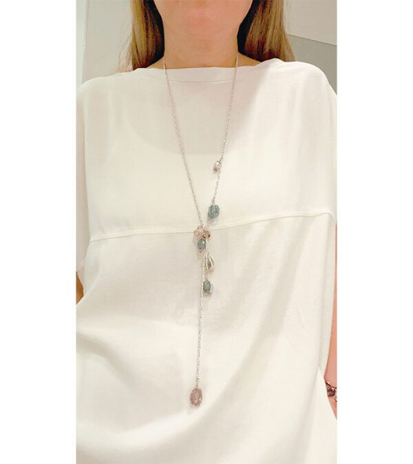 A woman wearing a white shirt and an NK8894 necklace.