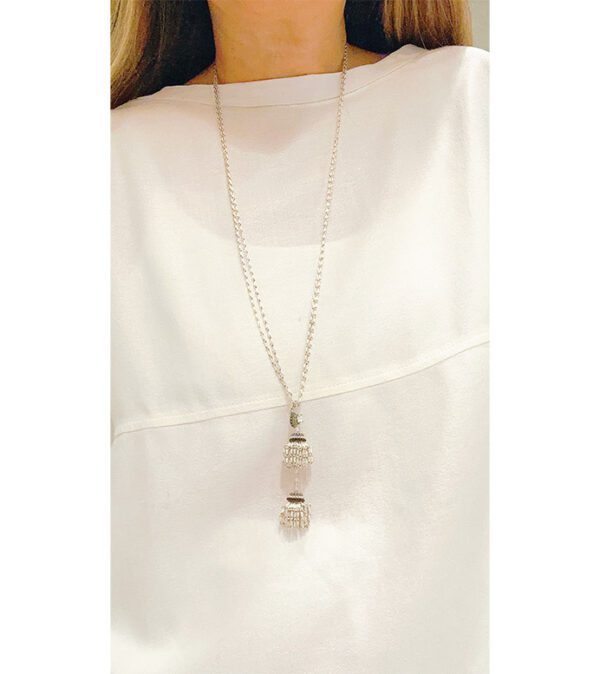 A woman wearing a white shirt and the NK8003 necklace.