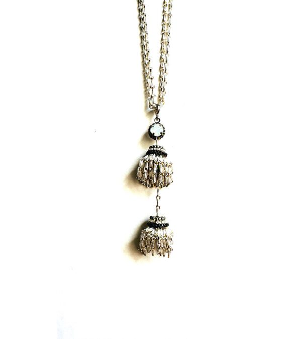 A NK8003 necklace with two tassels hanging from it.