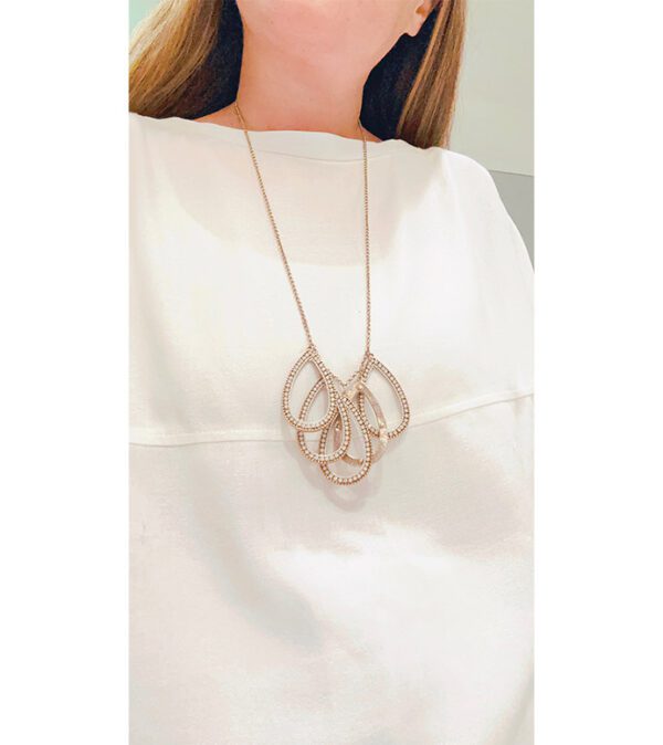 A woman wearing a white top and an NK6062 necklace.