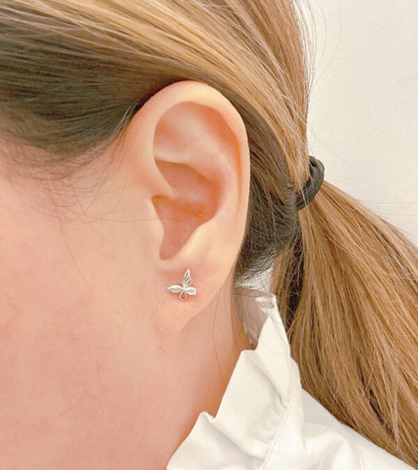 A woman's ear with product E0741.