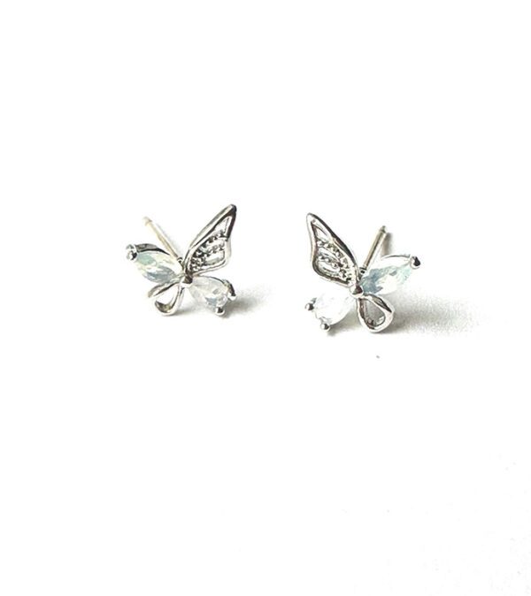 A pair of E0741 stud earrings on a white surface.