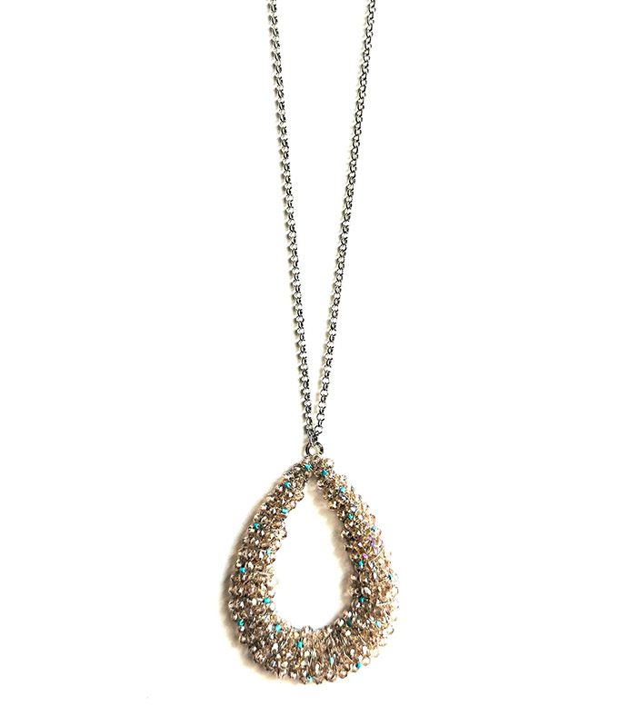 A NK1060 with a tear shaped pendant on a chain.