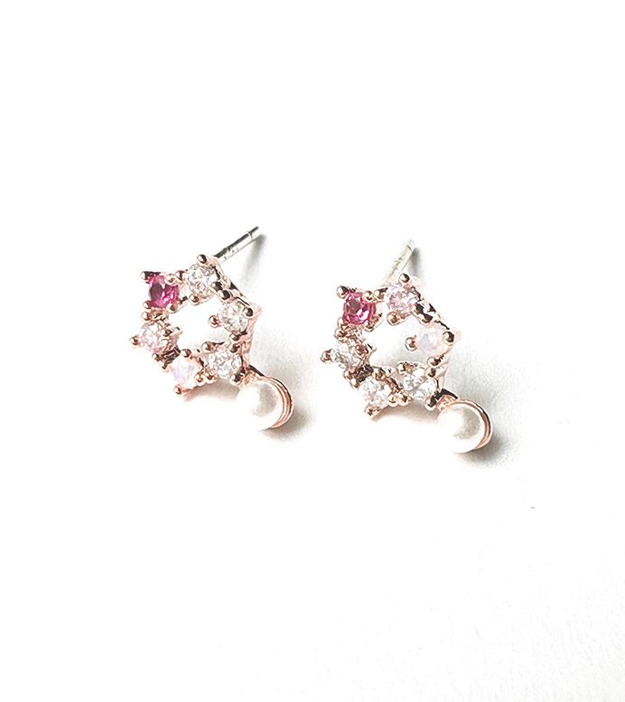 A pair of E0735 stud earrings on a white surface.