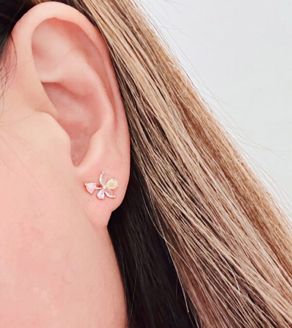 A woman's ear with a E0731 stud earring.