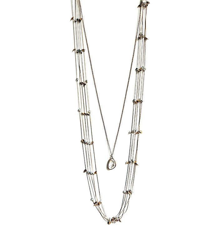 A NK333 necklace with silver beads and a pendant.