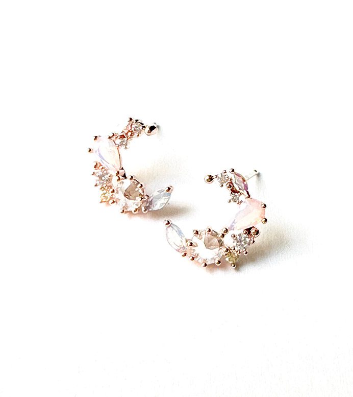 A pair of E0729 hoop earrings on a white surface.