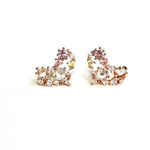 A pair of E0726 stud earrings on a white surface.