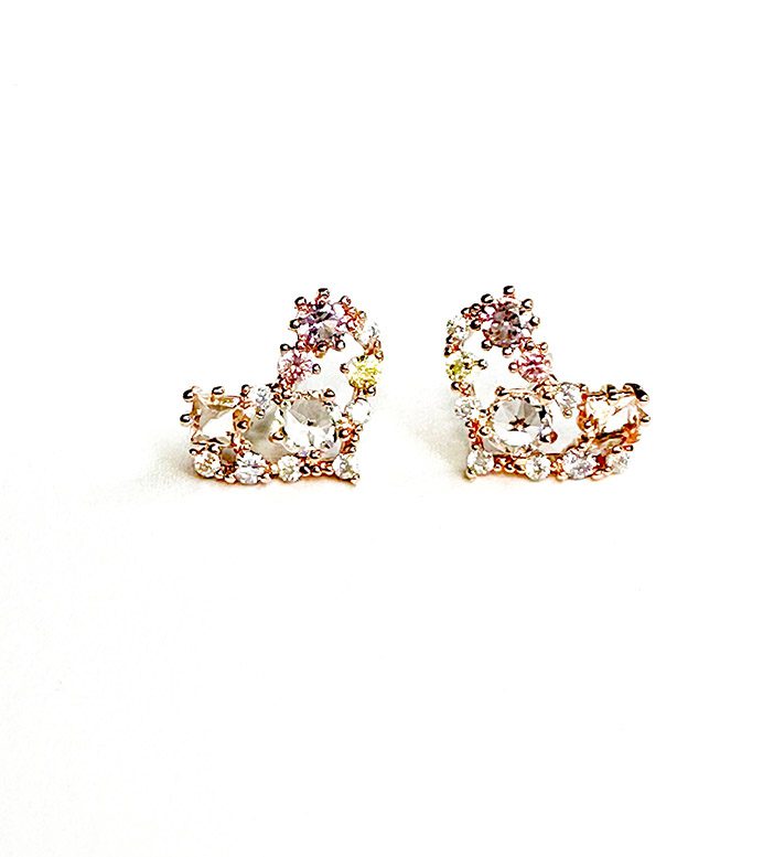 A pair of E0726 stud earrings on a white surface.