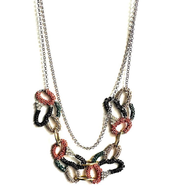 A multi - colored chain necklace NK090 on a white background.