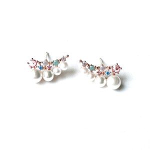 A pair of E670 earrings with pearls and crystals on a white surface.