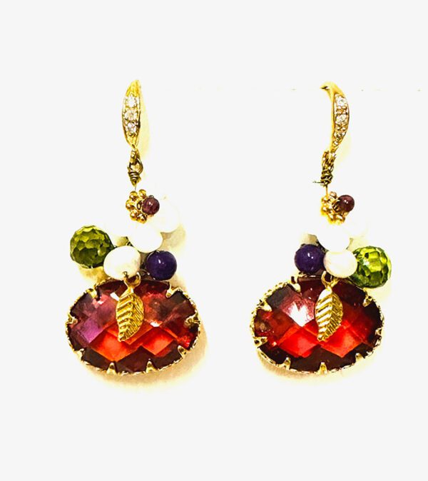 A pair of E00409 (Ruby) earrings with red and green stones.