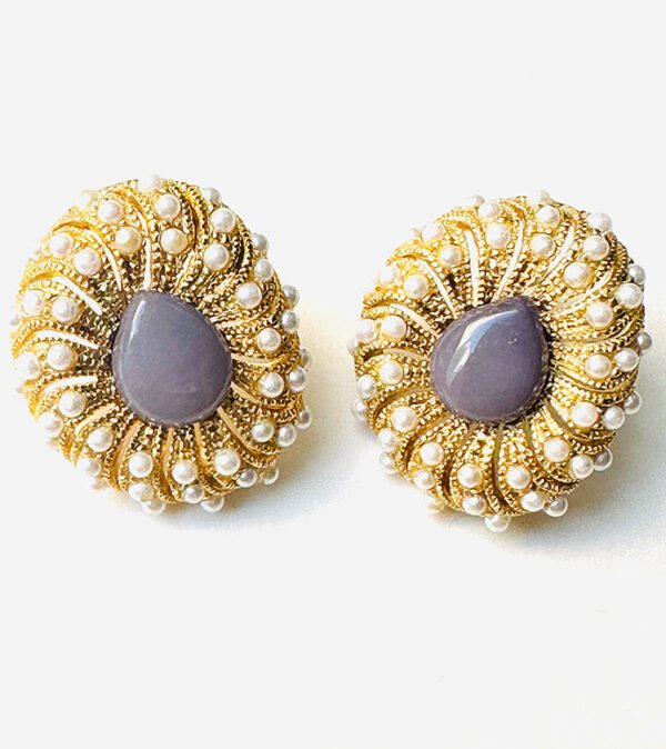 A pair of E102634 (Gold) earrings with a purple stone and pearls.