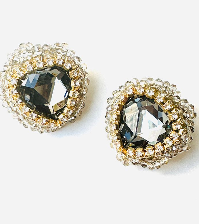 A pair of earrings with black crystals and E81154 (Gold) beading.