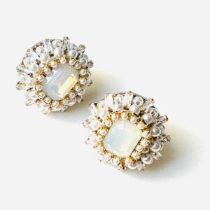 A pair of E24812 (White) stud earrings on a white surface.