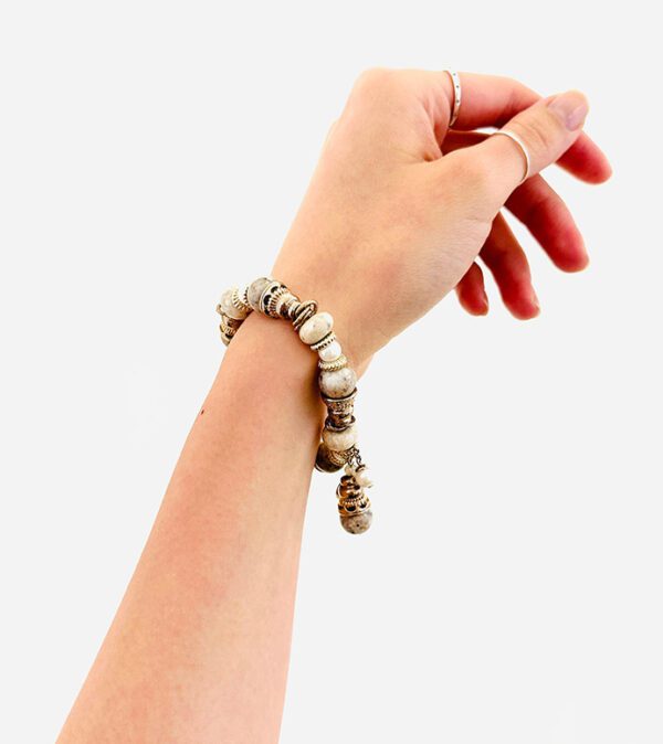 A woman's hand holding a B9164 beaded bracelet.