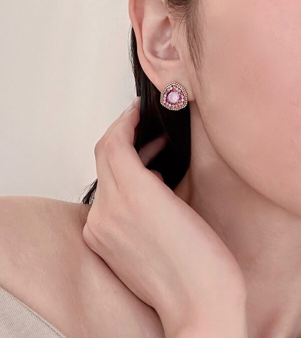 A woman wearing a pair of E9192 (Lavender) earrings.