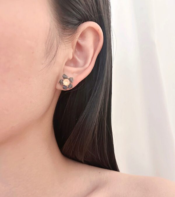 A woman wearing a pair of E9181 earrings.