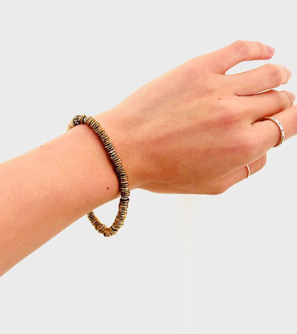 A woman's hand with a B5098 bracelet on it.