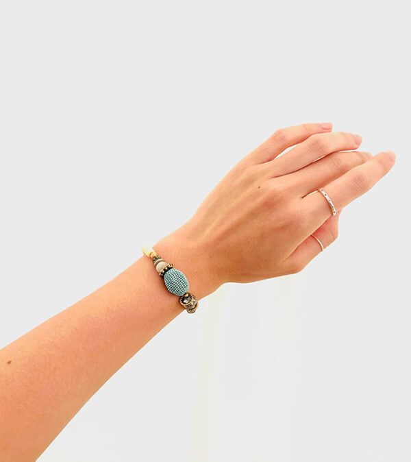 A woman's hand with a B3203 bracelet on it.