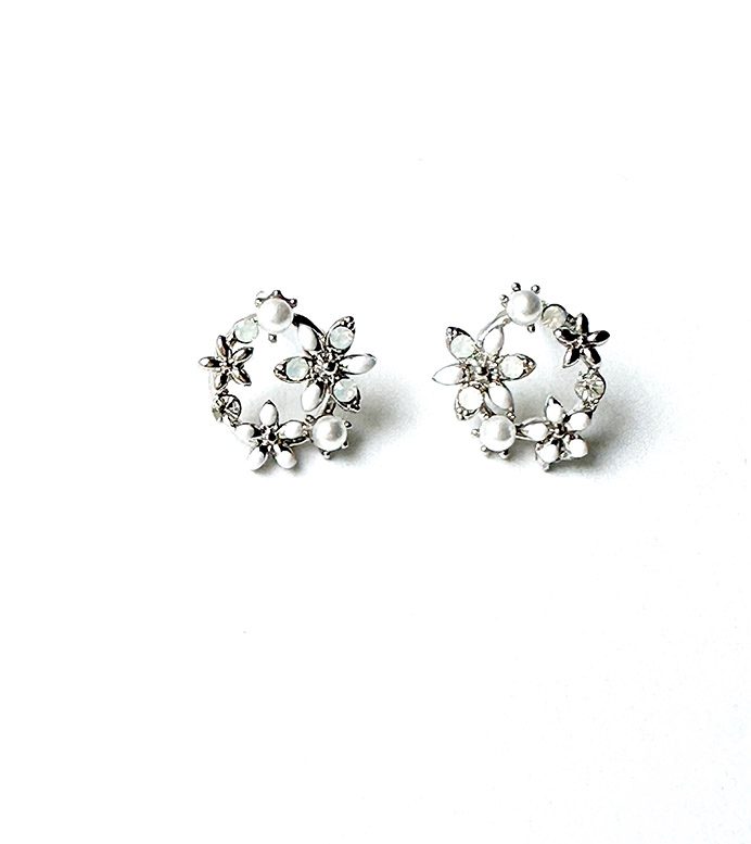 A pair of E8837 stud earrings on a white surface.