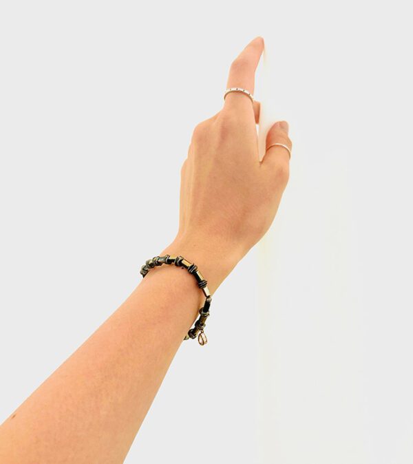 A woman's hand pointing to a B1010 on a wall.