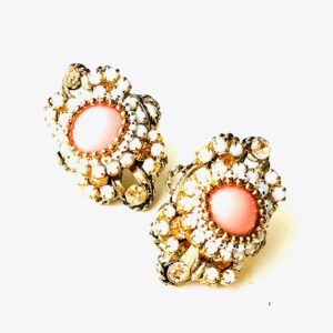 A pair of E8541 (Rose) earrings on a white surface.