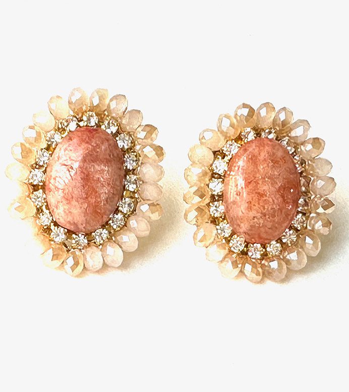 A pair of E8213 with coral stones and diamond earrings.