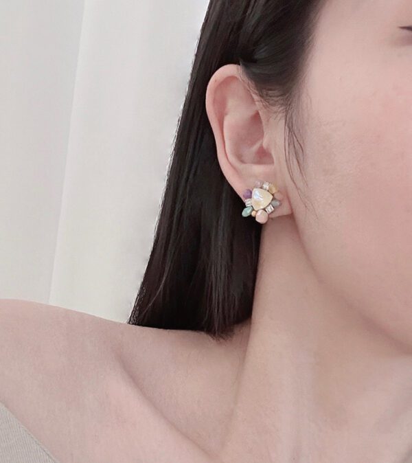 A woman wearing an E2489 (Multi) earring.