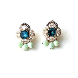 A pair of E2488 (Blue) stud earrings on a white surface.