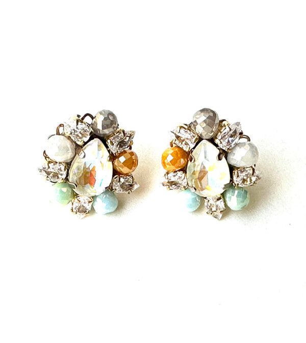 A pair of E2481 earrings with rhinestones and pearls.