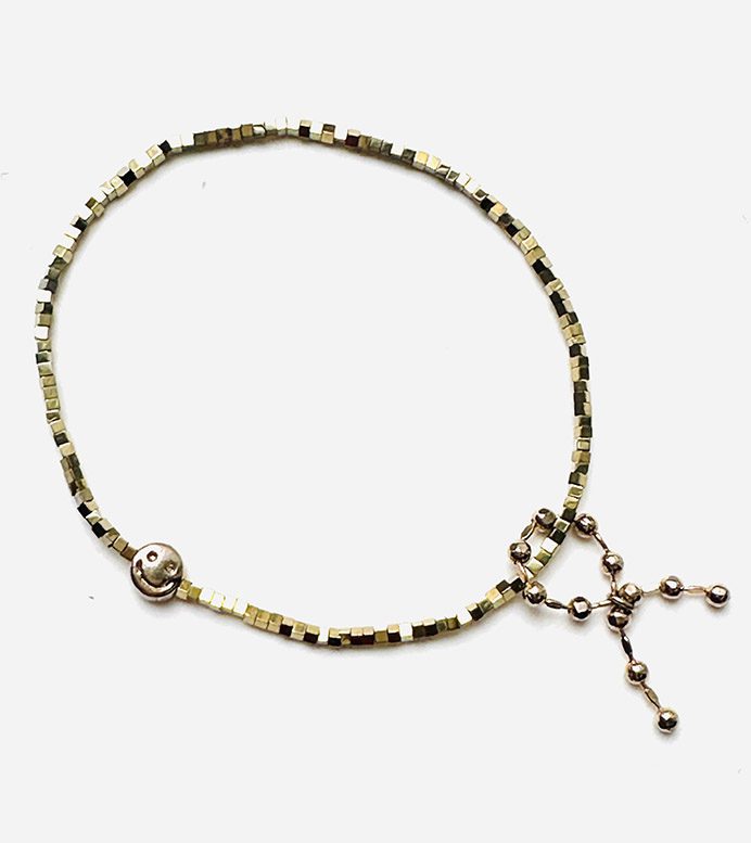 A B208 beaded bracelet with a charm on it.