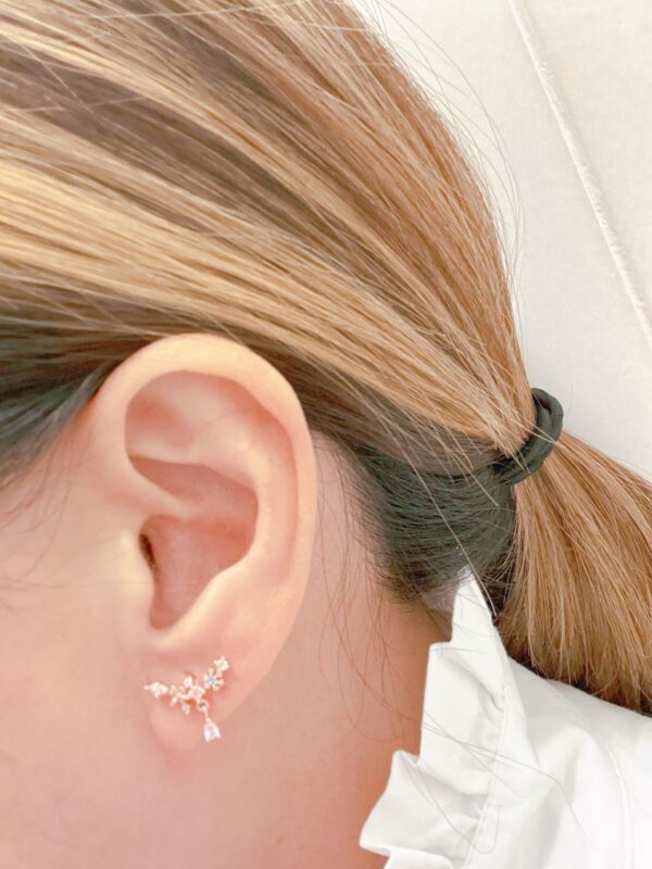 A woman's ear with a pair of E0738 ear cuffs.