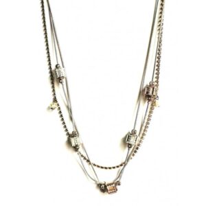 A silver and gold NK1500 necklace with a few beads on it.