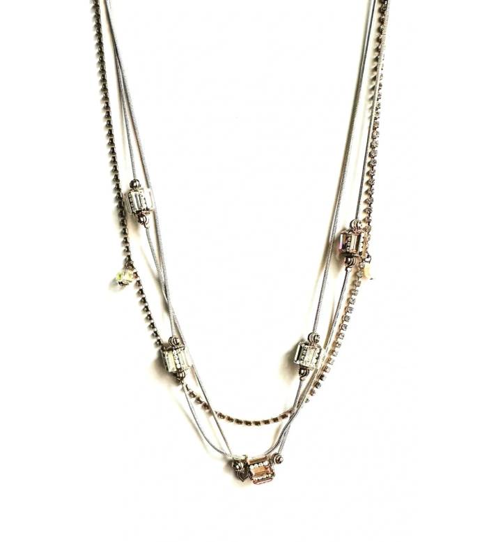 A silver and gold NK1500 necklace with a few beads on it.