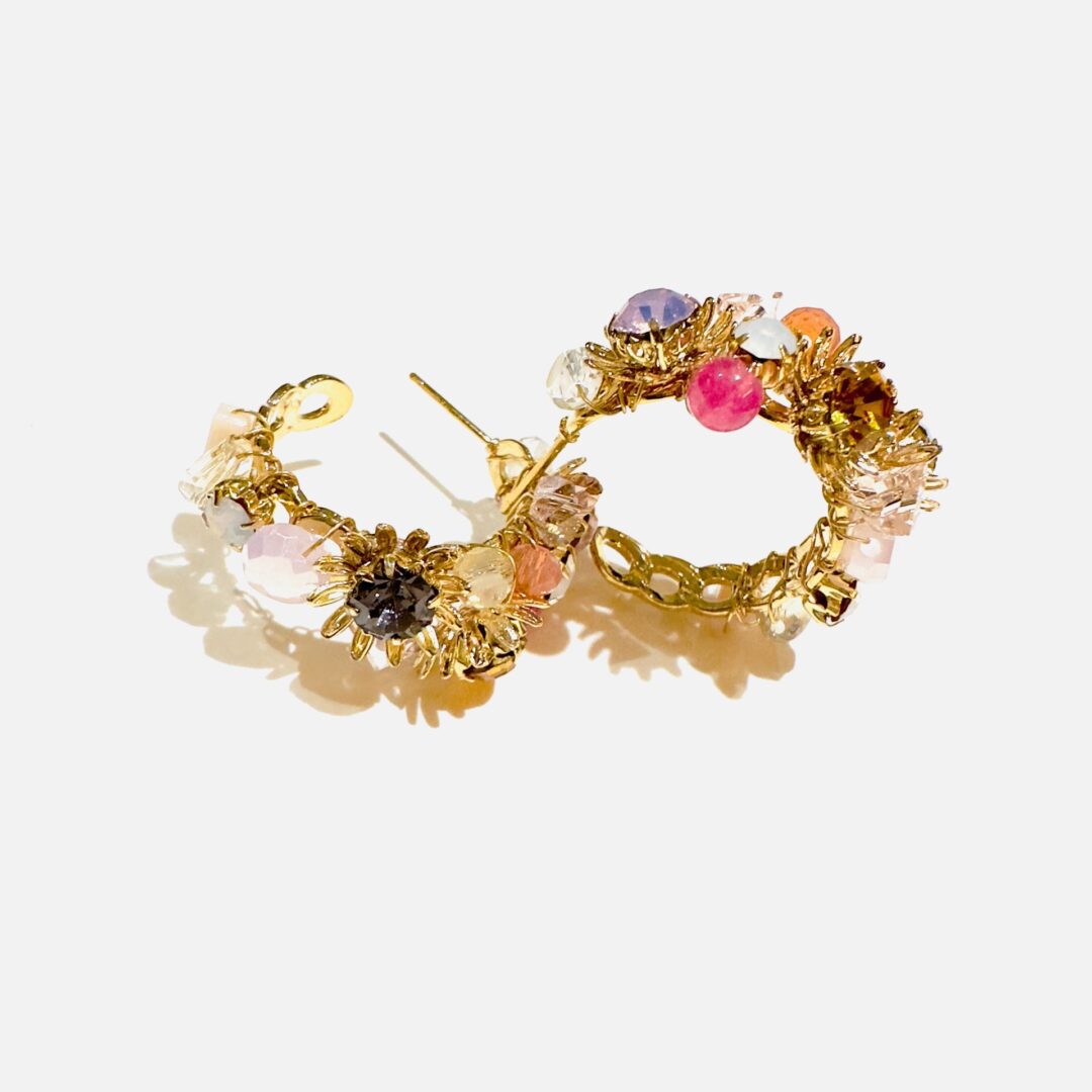 A pair of E5003 (Holiday) hoop earrings with colorful stones.