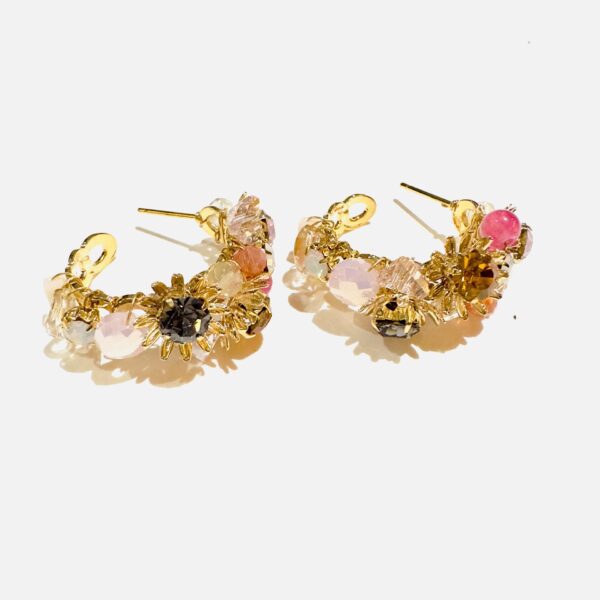 A pair of E5003 (Holiday) hoop earrings with pink and black stones.