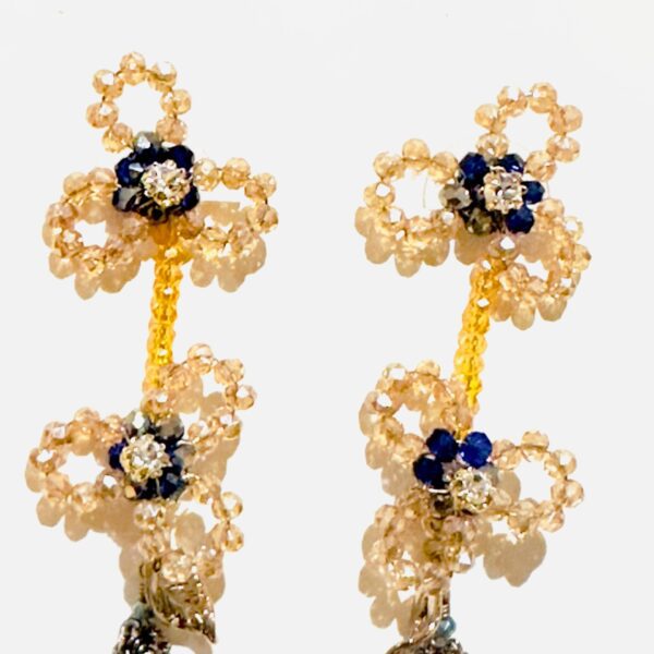 A pair of E5020 (Holiday) earrings with blue and gold beads.